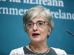 In this photo taken on Tuesday, Oct. 23, 2018, Children's Minister Katherine Zappone announces the forensic excavation of the site of a former mother and baby's home in Tuam, at Government Buildings in Dublin.  Ireland's government has approved a forensic excavation of a Catholic-run orphanage where a mass grave containing the remains of hundreds of children was discovered. The excavation follows a report from a judge-led commission that confirmed underground chambers at the former Bon Secours Mother and Baby Home in Tuam, County Galway, contained "significant quantities of human remains."