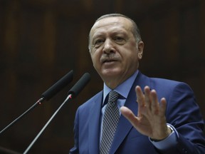 Turkey's President Recep Tayyip Erdogan addresses supporters at the parliament, in Ankara, Tuesday, Oct. 30, 2018.  Erdogan said the Turkish prosecutor repeated to his Saudi counterpart Turkey's extradition request of 18 suspects detained in Saudi Arabia for the Oct. 2 killing to be put on trial in Istanbul.