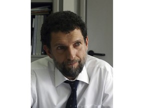 FILE - April 29, 2015 file photo of Osman Kavala, taken in Istanbul. Kavala, a Turkish businessman and activist who was arrested a year ago and no an indictment has been issued yet. Under global scrutiny, Turkey vows to get to the bottom of the alleged killing of a Saudi journalist at the kingdom's consulate in Istanbul. But some observers see a double standard in promises of transparency from a government accused of stifling freedom of expression. (AP Photo, File)
