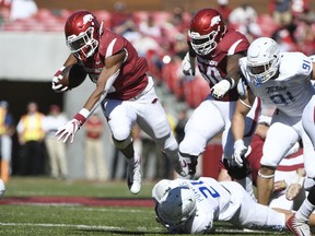 Arkansas running back Rakeem Boyd, top, gets past Tulsa defender Bryson Powers as he runs the ball in the first half of an NCAA college football game Saturday, Oct. 20, 2018, in Fayetteville, Ark.