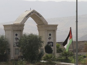 A Jordanian flag flies on a bridge leading from Israel to Jordan, in the Jordan valley area called Baqura, Jordanian territory that was leased to Israel under the 1994 peace agreement between the two countries, Monday, Oct. 22, 2018. Jordan's King Abdullah II on Sunday said he has decided not to renew the lease on two small areas of Baqura and Ghamr, that was part of his country's landmark peace treaty with Israel. The leases expire next year after 25 years.