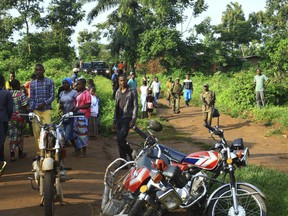 In this photo taken Friday, Oct 5, 2018, Congolese Soldiers patrol in an area civilians were killed by The Allied Democratic Forces rebels in Beni, Eastern Congo.  Congo’ military said Sunday Oct. 21, 2018, that rebels attacked an Ebola treatment centre in Beni, leaving over a dozen civilians dead and abducted about a dozen children, which could force crucial virus containment efforts to be suspended in the area.