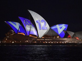 The barrier draw results for NSW Racing's multi-million dollar race, The Everest, are projected onto the sails of the Opera House, Sydney, Tuesday, Oct. 9, 2018.