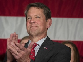 FILE - In this July 26, 2018, file photo, Georgia Secretary of State Brian Kemp appears during a unity rally, in Peachtree Corners, Ga. Former state Rep. Stacey Abrams has accused Kemp of suppressing access to the polls as their race heats up with roughly one month before the Nov. 6 election. But Kemp says Abrams and allied liberal activists are twisting his record of guarding Georgia elections against voter fraud.