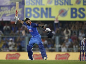 India's captain Virat Kohli celebrates after scoring a century during the first one-day international cricket match between India and West Indies in Gauhati, India, Sunday, Oct. 21, 2018.