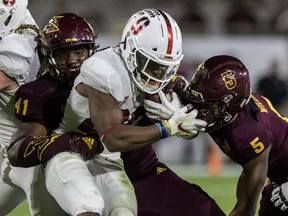 Stanford's Bryce Love gets stuffed at the line by Arizona State's Tyler Johnson (41) and Kobe Williams (5) during the first half of an NCAA college football game Thursday, Oct. 18, 2018, in Tempe, Ariz.