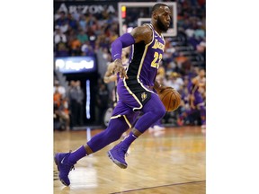 Los Angeles Lakers forward LeBron James (23) drives against the Phoenix Suns during the first half of an NBA basketball game, Wednesday, Oct. 24, 2018, in Phoenix.