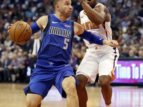 Dallas Mavericks guard J.J. Barea (5) drives past Phoenix Suns guard Isaiah Canaan during the first half of an NBA basketball game, Wednesday, Oct. 17, 2018, in Phoenix.