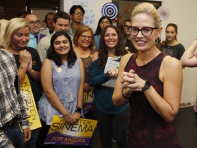 Democratic Rep. Kyrsten Sinema, who is running against Republican Rep. Martha McSally for the open Arizona Senate seat Jeff Flake, R-Ariz., is vacating, talks to campaign volunteers, Tuesday, Oct. 2, 2018, in Tempe, Ariz. Arizona's Senate race pits Sinema, a careful politician running as a centrist in a Republican-leaning state, against McSally, a onetime Trump critic turned fan.