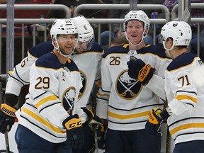 Buffalo Sabres defenseman Rasmus Dahlin (26) celebrates with Jason Pominville (29), Marco Scandella (6) and Evan Rodrigues (71) after scoring in the first period during an NHL hockey game against the Arizona Coyotes, Saturday, Oct. 13, 2018, in Glendale, Ariz.