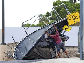 Joel Negrete, 510 S. Avenue A, begins moving a trampoline that was once in his yard before the start of Sunday's early afternoon rain storm. Tropical Storm Rosa neared Mexico's Baja California on Monday, spreading heavy rains that were projected to extend into a drenching of the U.S. Southwest.