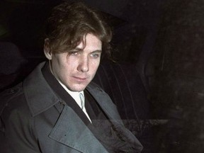 Paul Bernardo sits in the back of a police cruiser as he leaves a hearing in St. Catharines, Ont., April 5, 1994.