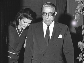 This file picture dated 20 June 1969 shows Jackie Kennedy (L) and Aristotle Onassis leaving their Avenue Foch' flat to have a dinner with friends.
