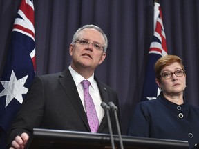 Prime Minister Scott Morrison, left, speaks to the media alongside Minister for Foreign Affairs Marise Payne during a press conference at the Parliament House in Canberra, Tuesday, October 16, 2018. Morrison said Tuesday that he was open to shifting the Australian Embassy from Tel Aviv to Jerusalem in line with President Donald Trump's decision to recognize the contested holy city as Israel's capital.