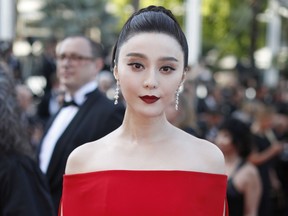 FILE - In this May 24, 2017, file photo, Chinese actress Fan Bingbing poses for photographers as she arrives for the screening of the film The Beguiled at the 70th international film festival, Cannes, southern France. The director of the film "Air Strike," featuring Fan Bingbing, says its release has been canceled in the wake of her disappearance and conviction on tax evasion charges.
