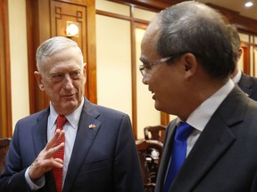 U.S. Secretary of Defense Jim Mattis, left, meets Ho Chi Minh City's communist party chief Nguyen Thien Nhan in Ho Chi Minh City, Vietnam, Tuesday, Oct. 16, 2018.