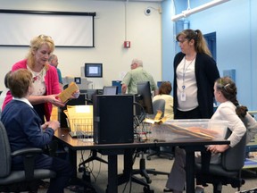 FILE - In this June 15, 2018 file photo, Maine election workers begin scanning and uploading election results trickling in from across the state, in Augusta, Maine. A new system known as ranked choice voting was used to decide results in the Democratic primary and also will be used in the November general election.