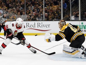 Ottawa Senators' Tom Pyatt (10) eyes a loose puck in front of Boston Bruins goaltender Tuukka Rask during the first period of an NHL hockey game Monday, Oct. 8, 2018, in Boston.