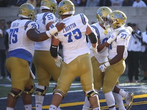 UCLA running back Joshua Kelley, right, celebrates after scoring a touchdown against California during the first half of an NCAA college football game Saturday, Oct. 13, 2018, in Berkeley, Calif.