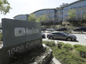 FILE - In this Tuesday, April 3, 2018 file, a YouTube sign is shown across the street from the company's offices in San Bruno, Calif. YouTube's video streaming service went out for more than an hour on Tuesday, Oct. 16, 2018, apparently affecting locations around the world. YouTube acknowledged the outage in a tweet at 9:41 p.m. EDT, noting that it affected YouTube, YouTube Music and YouTube TV.