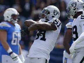 Oakland Raiders defensive end Bruce Irvin, center, reacts after sacking Los Angeles Chargers quarterback Philip Rivers during the first half of an NFL football game Sunday, Oct. 7, 2018, in Carson, Calif.