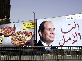 FILE - In this March 19, 2018 file photo, an election billboard for Egyptian President Abdel-Fattah el-Sissi, with Arabic that reads, "you are the hope," hangs in Cairo, Egypt. Egyptian security officials said Tuesday, Oct. 23, 2018, that police detained prize-winning economist Abdel-Khaleq Farouq and his publisher, Ibrahim el-Khateib, over a book that challenged el-Sissi's assertion that Egypt is a poor nation.