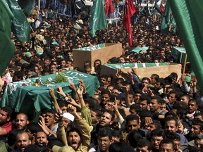 FILE - In this March 22, 2004 file photo, thousands of Palestinian mourners follow the coffin of Hamas spiritual leader Sheik Ahmed Yassin, during his funeral in Gaza City. Israeli helicopters fired missiles killing Yassin as he left a mosque near his house at daybreak. Israel and the Palestinians have a history of assassinations. Israel's Mossad killed several top PLO and Hamas leaders in the Arab world and Gaza. A Palestinian splinter group attempted and failed to kill the Israeli ambassador to the United Kingdom in 1982 and Palestinian militants assassinated Israel's tourism minister in 2001.