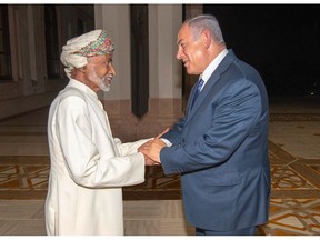 Oman's Sultan Qaboos, left, receives Israeli Prime Minister Benjamin Netanyahu in Muscat during Netanyahu's surprise visit there on Oct. 26, 2018.