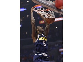 Denver Nuggets' Will Barton (5) dunks against the Los Angeles Clippers during the first half of an NBA basketball game Wednesday, Oct. 17, 2018, in Los Angeles.