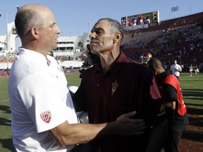 Arizona State head coach Herm Edwards, right, shakes hands with Southern California head coach Clay Helton after Arizona State's 38-35 win during an NCAA college football game Saturday, Oct. 27, 2018, in Los Angeles.