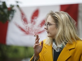 An attendee smokes a joint during a celebration of the legalization of cannabis at Trinity Bellwoods Park in Toronto, Ontario, Canada, on Wednesday, Oct. 17, 2018.