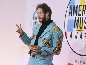 Post Malone arrives at the American Music Awards on Tuesday, Oct. 9, 2018, at the Microsoft Theater in Los Angeles.