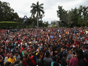 Members of an immigrant caravan gather before attempting to cross the Guatemalan border into Mexico on October 19, 2018 in Tecun Uman, Guatemala. The caravan of thousands of Central Americans, mostly from Honduras, hopes to eventually reach the United States. U.S. President Donald Trump has threatened to cancel the recent trade deal with Mexico and withhold aid to Central American countries if the caravan isn't stopped before reaching the U.S.