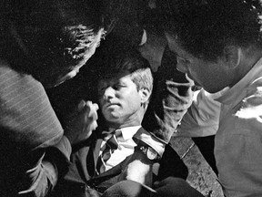Hotel busboy Juan Romero, right, comes to the aid of Senator Robert F. Kennedy, as he lies on the floor of the Ambassador hotel in Los Angeles moments after he was shot on June 5, 1968.