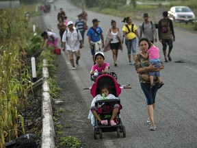 Central American migrants traveling with a caravan to the U.S. make their way to Pijijiapan, Mexico, Thursday, Oct. 25, 2018.