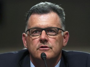 FILE - In this June 5, 2018 file photo, former USA Gymnastics president Steve Penny invokes his right under the Fifth Amendment during a hearing on Capitol Hill in Washington. Penny has pleaded not guilty to a charge in Texas of tampering with evidence in the sexual assault investigation of now-imprisoned gymnastics doctor Larry Nassar. Penny entered his plea during a court appearance in Huntsville, Texas, on Monday Oct. 29, 2018.