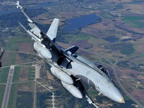 A Royal Canadian Air Force CF-18 Hornet performs manoeuvres over Lithuania in a file photo from a NATO operation on Sept.15, 2014. Canada's entire fleet of CF-18s is approaching absolute retirement age, writes David Krayden.