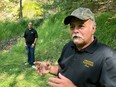 In this Sept. 20, 2018 photo, Dennis Parada, right, and his son Kem Parada stand at the site of the FBIs dig for Civil War-era gold in Dents Run, Pennsylvania.