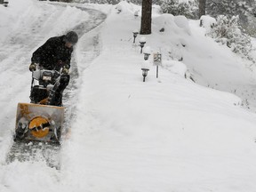 Scott Henderson plows his driveway on Sunday, Oct. 14, 2018 in Nederland, Colo. Nederland got over 10 inches of snow in this fall storm.