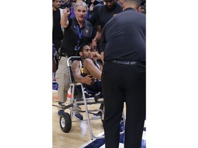 Denver Nuggets guard Will Barton is carted off the court after being injured during the third quarter of an NBA basketball game against the Phoenix Suns, Saturday, Oct. 20, 2018, in Denver.