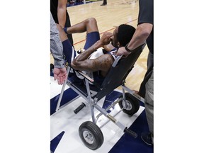 Denver Nuggets guard Will Barton is carted off the court after being injured during the third quarter of an NBA basketball game against the Phoenix Suns, Saturday, Oct. 20, 2018, in Denver.