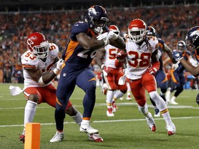 Kansas City Chiefs linebacker Anthony Hitchens (53) can't stop Denver Broncos running back Royce Freeman (28) from scoring a touchdown as defensive back Ron Parker (38) pursues during the first half of an NFL football game, Monday, Oct. 1, 2018, in Denver.