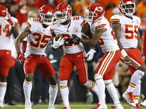 Kansas City Chiefs cornerback Eric Murray (21) celebrates his interception against the Denver Broncos with cornerback Charvarius Ward (35) and cornerback Steven Nelson (20) during the second half of an NFL football game, Monday, Oct. 1, 2018, in Denver.