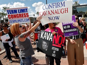 Anti- and pro-Brett Kavanaugh protesters face off outside the office of Republican Sen. Jeff Flake on Oct. 4, 2018, in Phoenix.