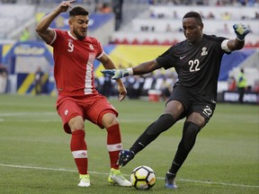 Canada forward Lucas Cavallini, left, battles French Guiana goalkeeper Donovan Leon for the ball during the first half of a CONCACAF Gold Cup soccer match in Harrison, N.J., on July 7, 2017. Together they likely rank as Canada's top soccer players currently plying their trade in North America. And Lucas Cavallini and Jonathan Osorio go way back. Both are gearing up for Canada???s CONCACAF Nations League qualifying match against Dominica on Tuesday.