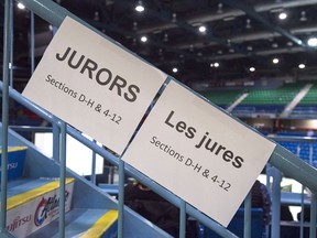 Signage directs potential jurors at jury selection for the retrial of Dennis Oland in the bludgeoning death of his millionaire father, Richard Oland, at Harbour Station arena in Saint John, N.B., on Monday, Oct. 15, 2018. The first two groups of prospective jurors will be at the Saint John law courts today as jury selection begins for the second-degree murder trial of Dennis Oland in New Brunswick.