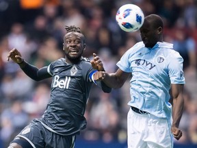 Sporting Kansas City's Ike Opara, right, gets his head on a pass intended for Vancouver Whitecaps' Kei Kamara during the second half of an MLS soccer game in Vancouver, on Wednesday October 17, 2018. The Vancouver Whitecaps have one last shot at keeping their playoff hopes alive.