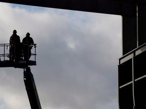 Workers are pictured at the Vancouver Shipyard in an October 7, 2013, file photo. Statistics Canada says the country gained 63,000 jobs in September, edging the unemployment rate lower to 5.9 per cent.