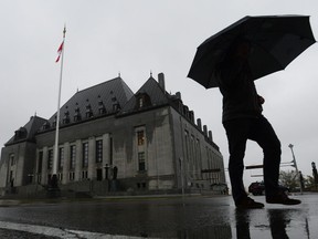 A man walks pass the Supreme Court of Canada in Ottawa on Thursday, Nov. 2, 2017. The Supreme Court of Canada is setting limits around the release of certain records people facing drunk-driving charges use to question breathalyzer results.