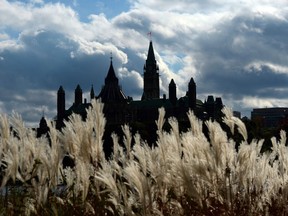 Parliament Hill in Ottawa is viewed from the shores of Gatineau, Quebec on Oct. 22, 2013. A new analysis by the federal budget watchdog says the government is on track to run deeper-than-expected deficits in each of the next few years.
